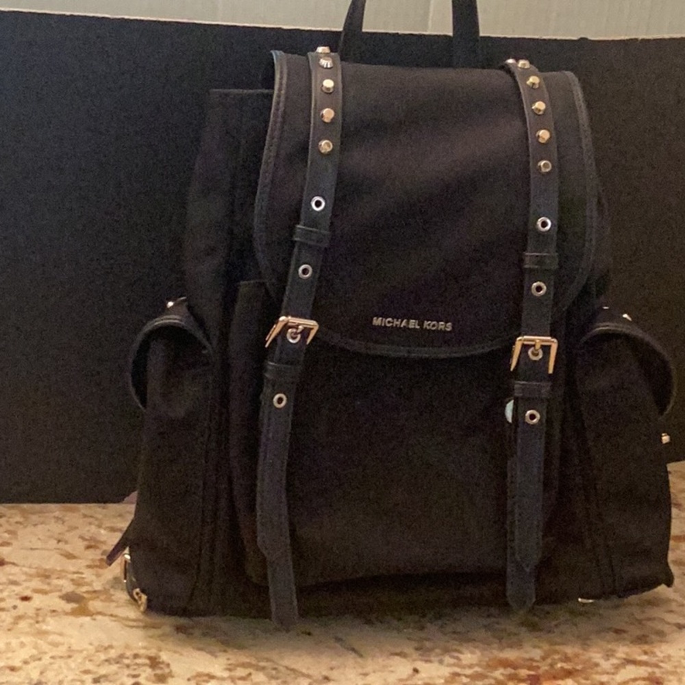 Michael Kors black with gold hardware backpack.